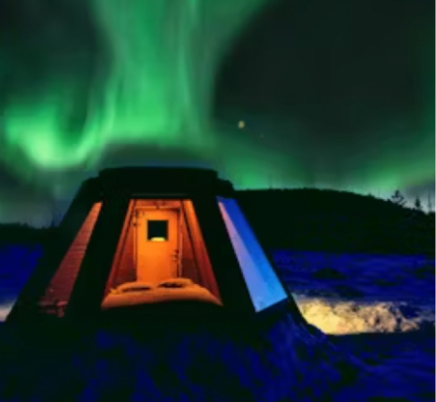 A tepee with the northern light above